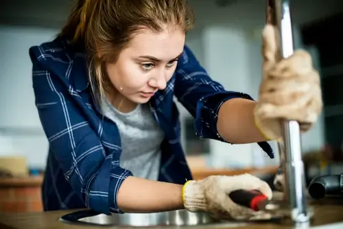 Reliable plumbers in Watford installing a new kitchen faucet and fixing sink leaks.