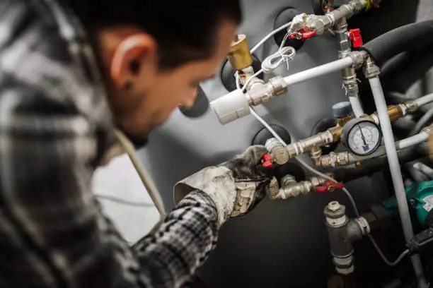 Professional plumbers in Watford performing complex boiler pipework and maintenance.